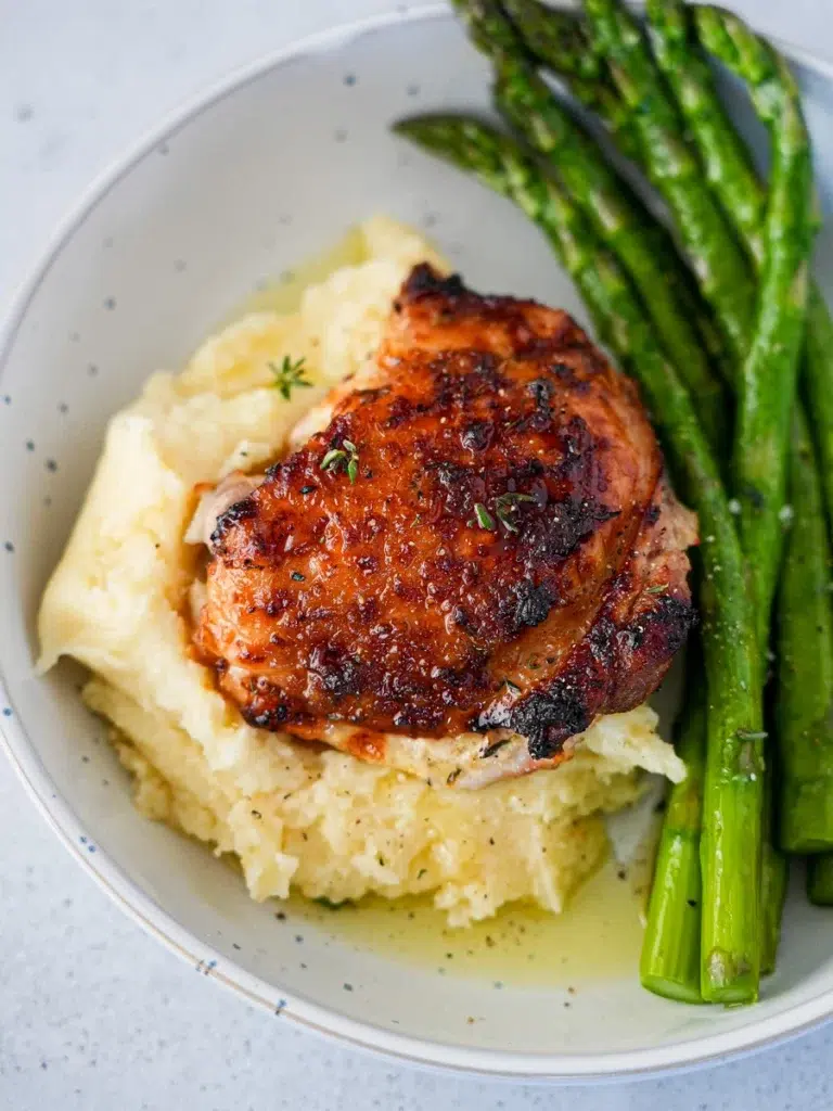 Garlic Butter Chicken Thighs with mashed potatoes and asparagus